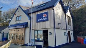 Photo of Little and Broad Haven's RNLI Shop from street level, facing the building.
