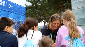 Photo of an RNLI Water Safety officer speaking to a group of children