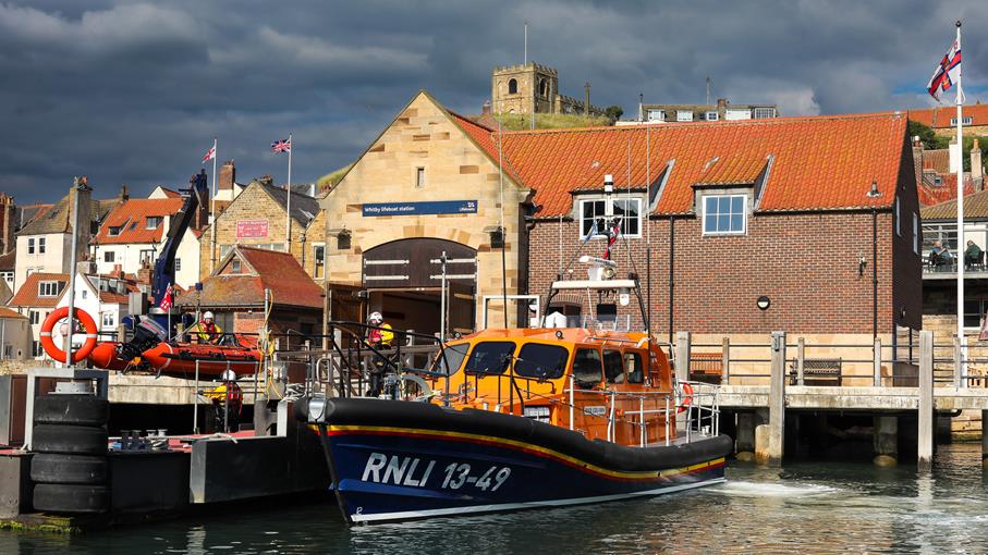 Whitby's Shannon class lifeboat afloat in front of Whitby lifeboat station.