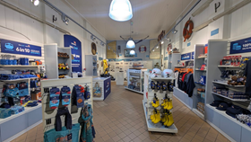 Inside an RNLI shop with various items on shelves for sale