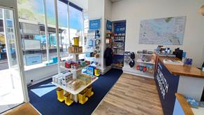 inside of a blue and white shop with a map on the wall.