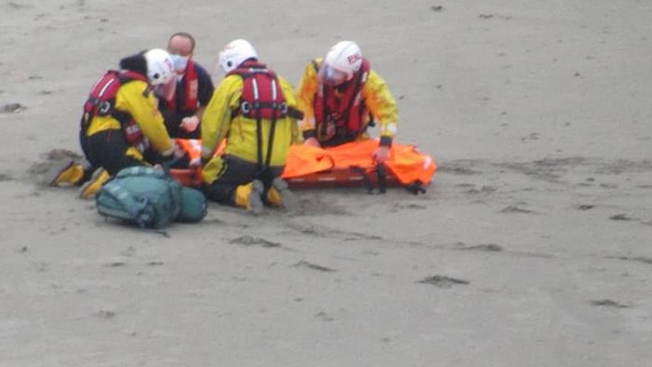 Looe lifeboat crew work to stabilise the casualty