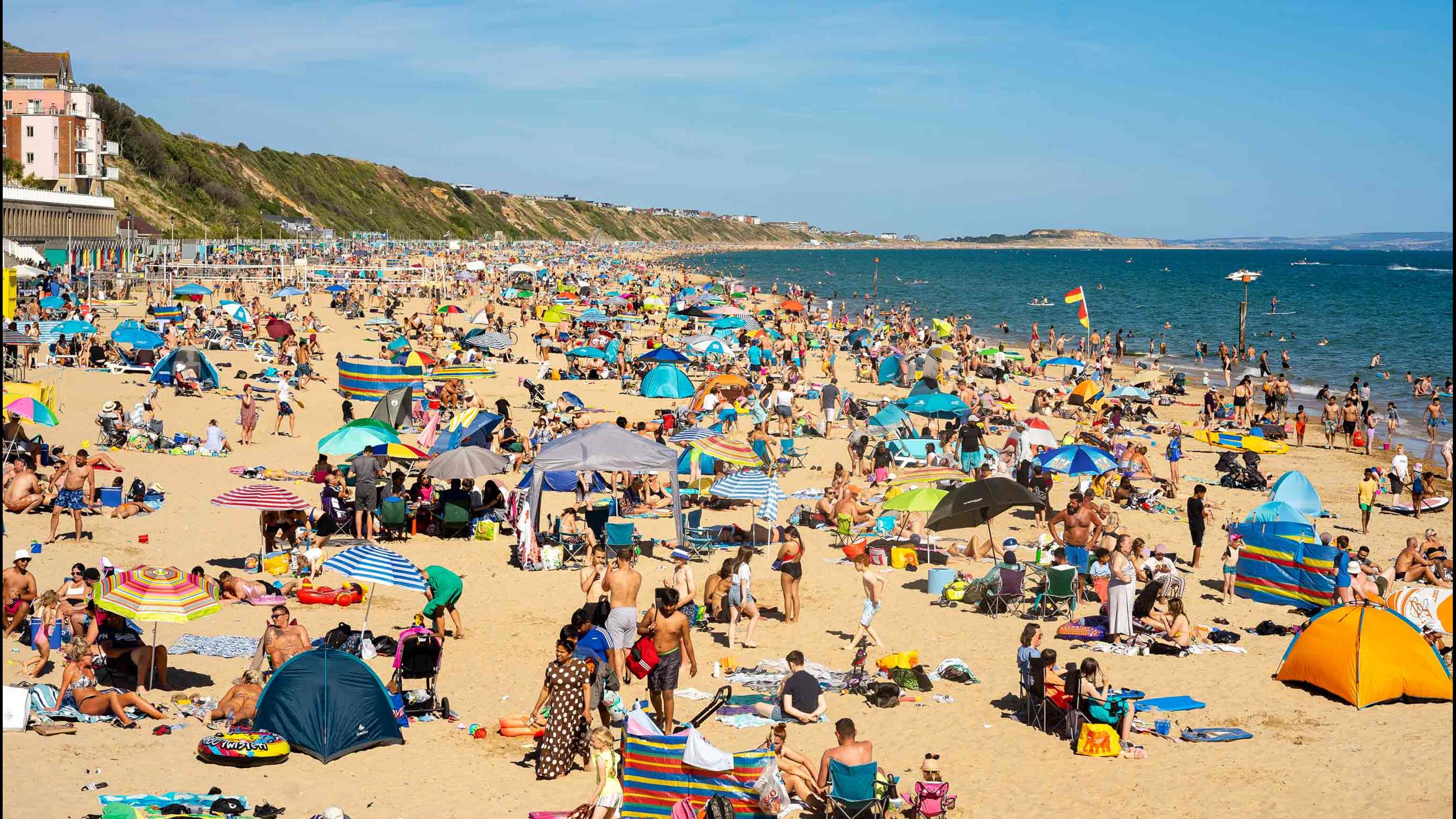 Photo of a busy beach in Boscombe during the summer lifeguard season. 