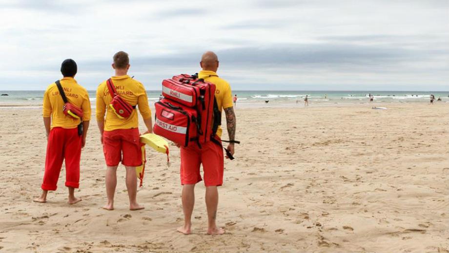 RNLI lifeguards on the beach at Mawgan Porth