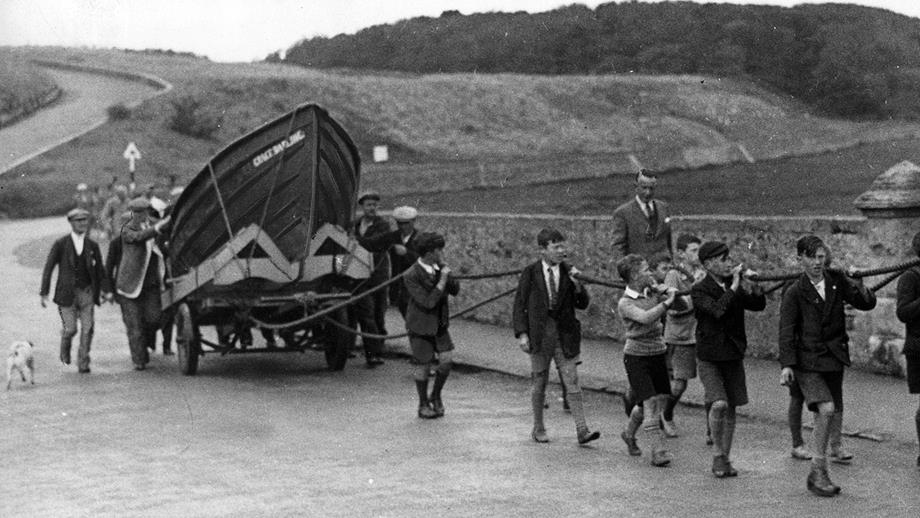 In 1938 the coble from the Darling rescue is towed by children to its new home at the Grace Darling Museum  