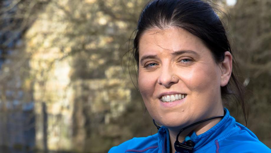 Aggie Kwiecien, wearing a blue tracksuit top and smiling into the camera