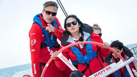 Kari Andersen from Helly Hansen steering a boat in sailing gear