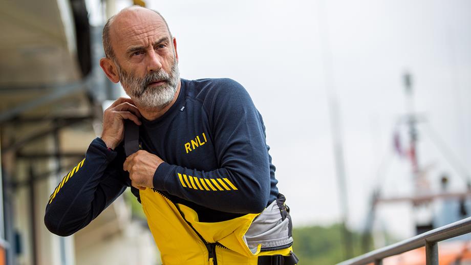 An RNLI crew member wearing Helly Hansen crew kit
