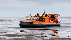 RNLI Hoylake’s orange hovercraft, Hurley Spirit, powers across the shore after a call-out 