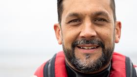 A portrait of Cardigan Crew Member Simon Mansfield, who smiles at the camera