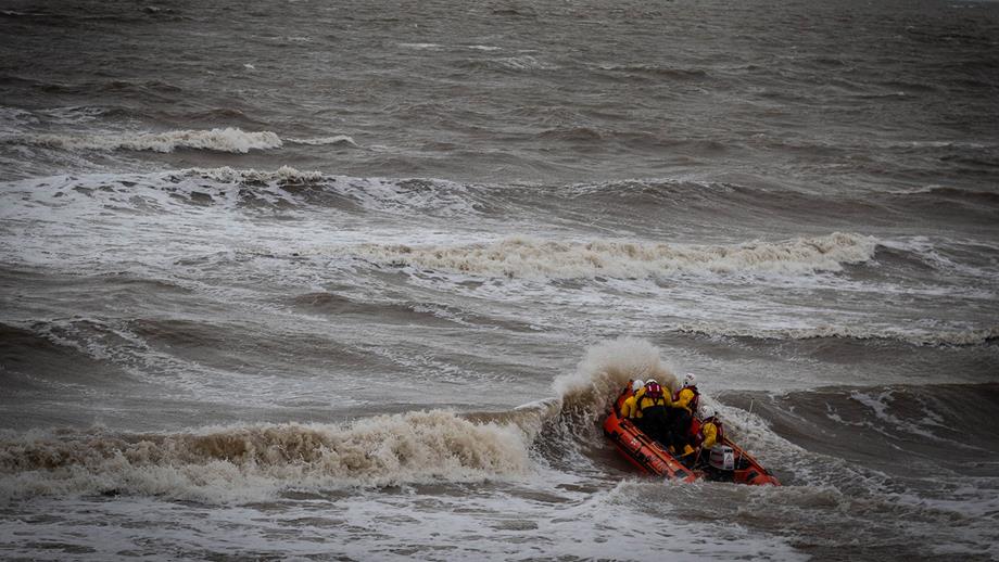 Rhyl RNLI crashing through waves in Mary Maxwell, their D class inshore lifeboat