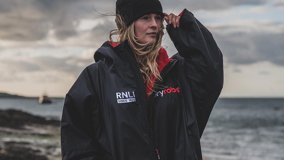 Woman wearing a black and red Advance Long Sleeve dryrobe, priced £175.