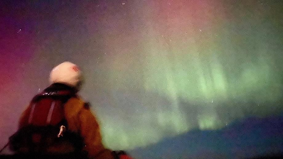 The glowing green and pink of the aurora borealis