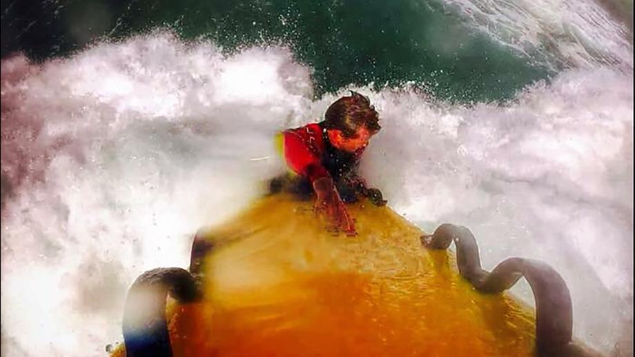 Charlie Gillett, Lead Lifeguard Supervisor, on a rescue board in big surf on Tregantle Beach. The photo is taken from a GoPro camera attached to the rescue board.