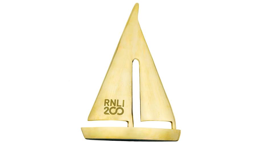 Brass yacht with RNLI 200 logo on the sail, priced £40.