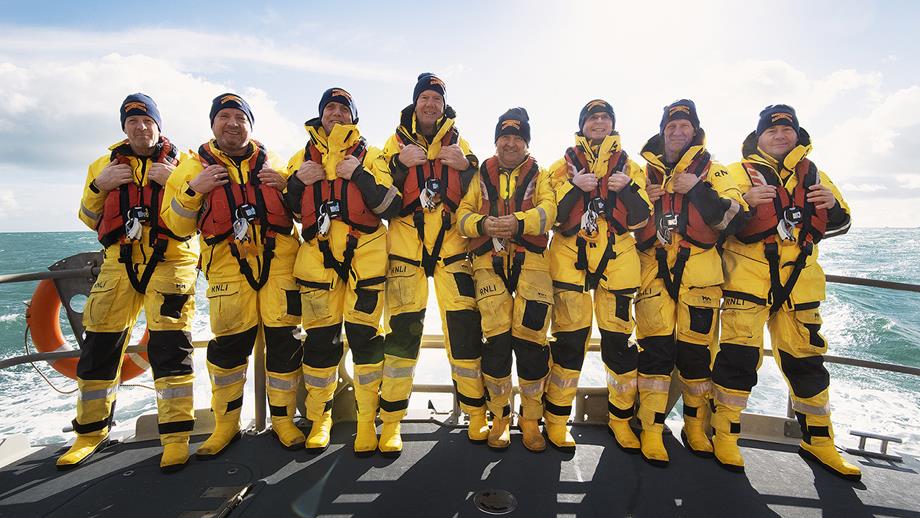 Eight crew members from Torbay RNLI on the deck of their lifeboat