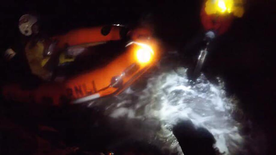 The Wick RNLI crew, in their small inflatable lifeboat, in choppy waters