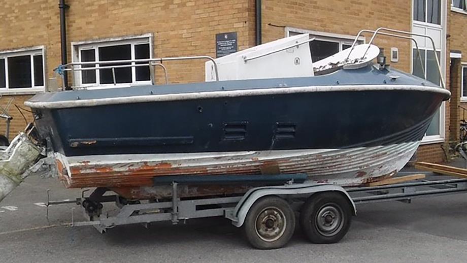 The A class lifeboat before Steve and his fellow volunteers worked on it. The paint is flaking, and the inside of the boat is covered in debris. 