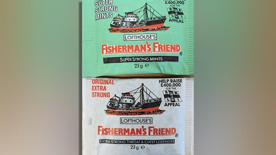 Two packets of Fisherman’s Friends lozenges. One packet is green and the other packet is white. On both packets, there is bold red text that reads, ‘Fisherman’s Friend’, as well as an illustration of a fishing boat.