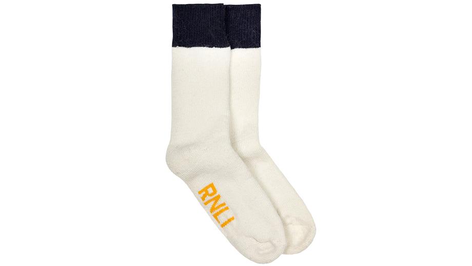 Thick ecru and navy boot socks, with ‘RNLI’ printed on the bottom in orange