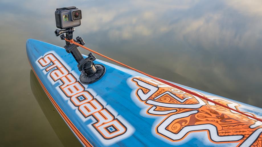 A camera mounted on the front of a blue and orange paddleboard
