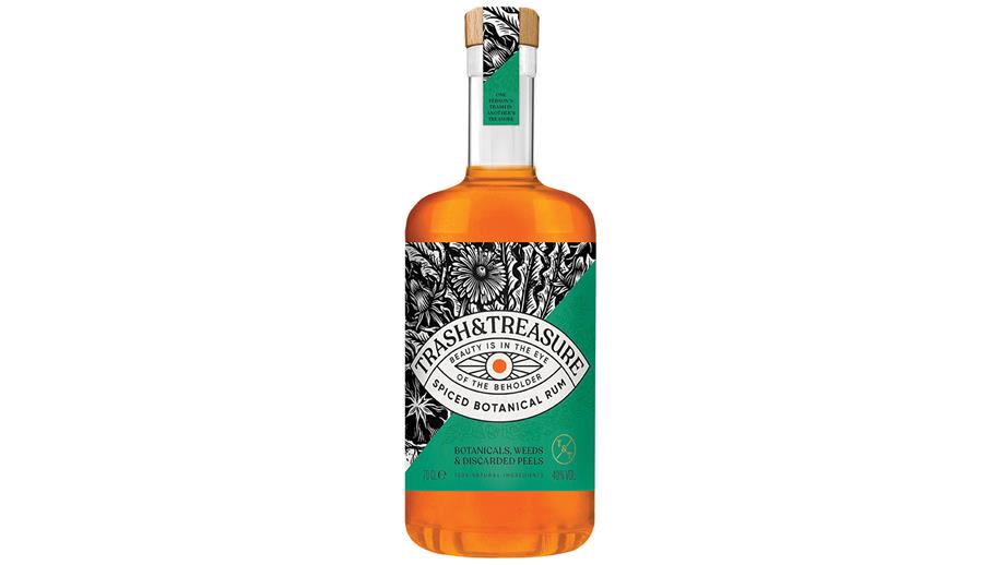 A bottle of Trash and Treasure Botanical Rum with an eye-catching label in a bold black and white pattern. 