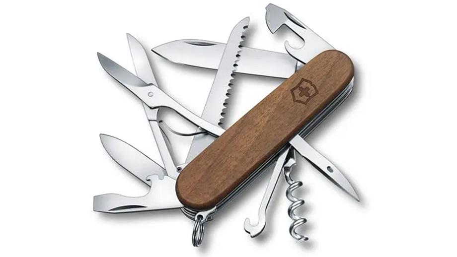 An open Victorinox Huntsman Pocket Knife, displaying its 13 tools. They include a corkscrew, a can opener, blades and scissors.