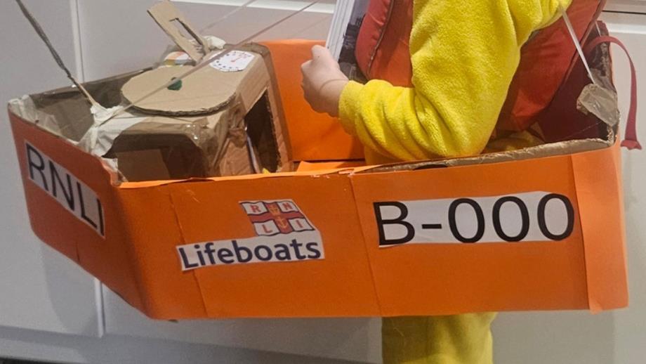 Close up photo of the logo and details added to Ghillys handmade cardboard lifeboat