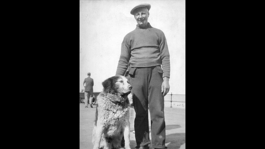 Henry Blogg and his dog Monte pose for a photo at the seaside