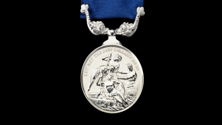 The RNLI Silver Medal for Gallantry, depicting three lifesavers pulling a man from the sea.