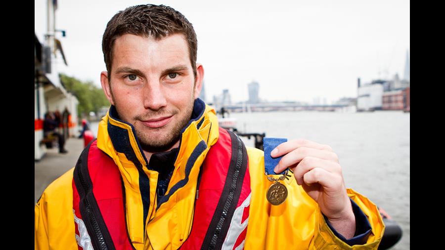 Porthcawl Lifeboat Station’s Chris Missen, holding up his Bronze Medal for Gallantry 