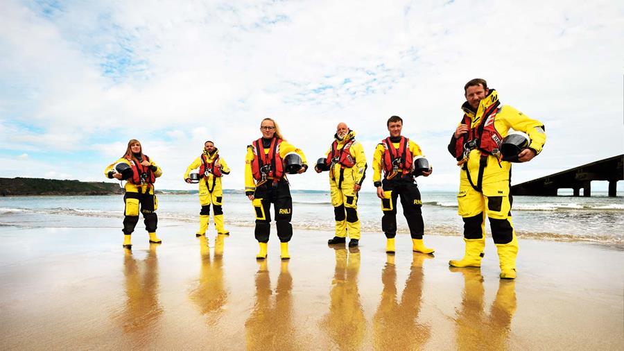 Group of RNLI crew members on the beach