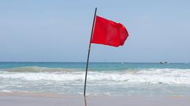 Red flag flying at the beach