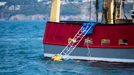 A commercial fishing vessel with an A-frame
