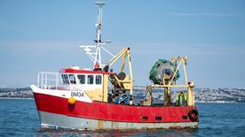 A commercial fishing vessel with an A-frame