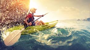 Kayaker paddling at sea