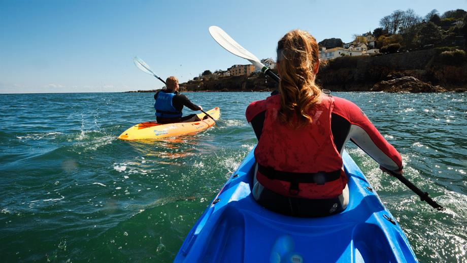 Kayakers paddling at sea