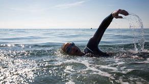 A man is swimming in open water.