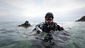 Divers in the sea during a search and rescue exercise with RNLI Torbay.