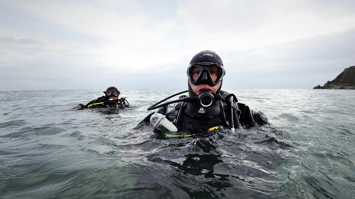 Divers in the sea during a search and rescue exercise with RNLI Torbay.