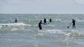 Paddle boarders in choppy seas at Brighton, East Sussex