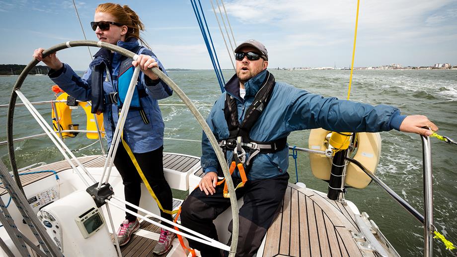 Yacht sailing: Crew at the helm