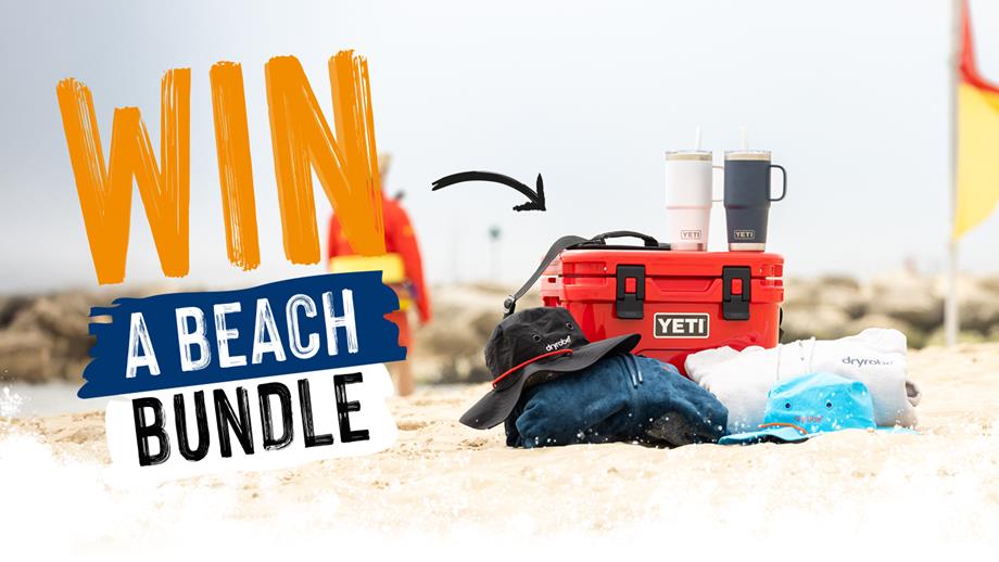 Win a beach bundle: a yeti cooler and two yeti mugs on a lifeguarded beach alongside two dryrobe towel robes and hats.