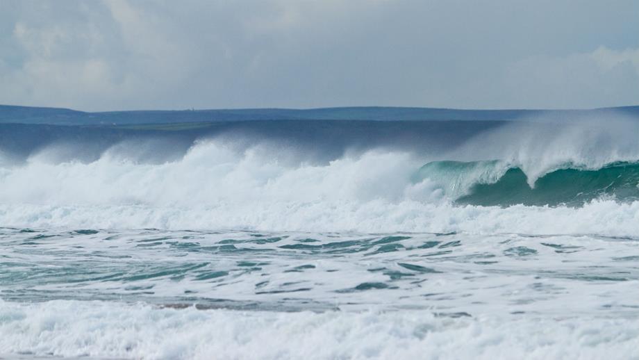 A large wave breaking at Porthtowan Beach