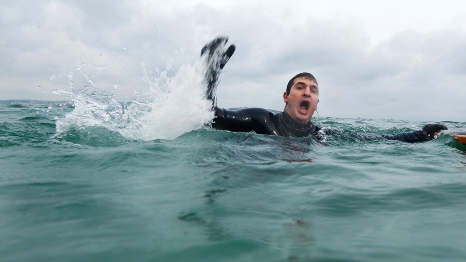 Man struggling to stay afloat in the water