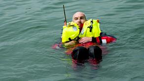 A man in the water with a lifejacket on