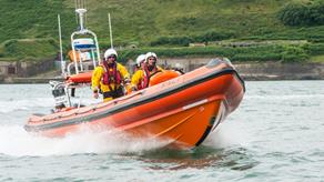 Crosshaven atlantic boat on water with crew members aboard