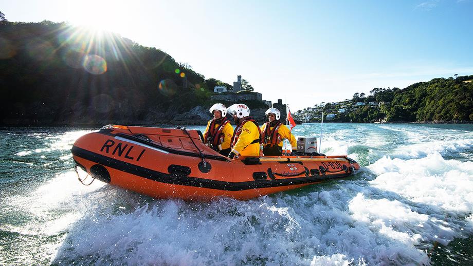 Dart lifeboat volunteers crew motor out of the Dart Estuary in their D class lifeboat Spirit of the Dart