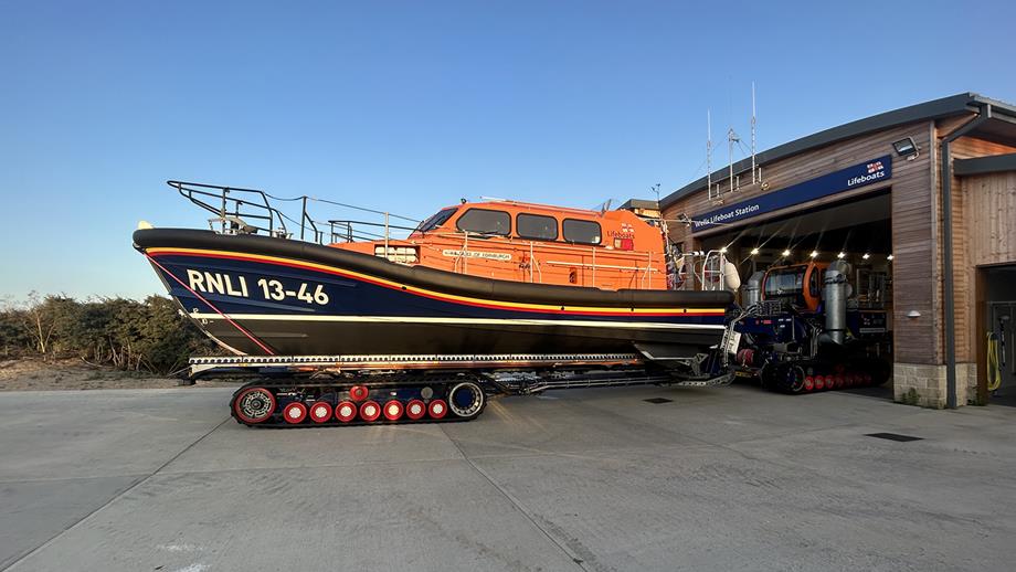 The Wells lifeboat being pushed out of its boathouse on a trailer by a launch and recovery tractor.