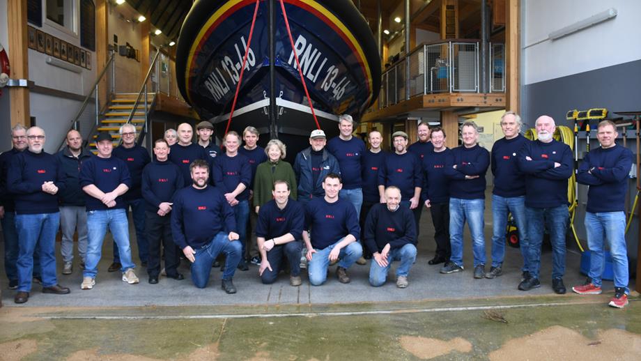 A group photo of long-serving Wells RNLI volunteers outside the boathouse in front of the station’s Shannon class all-weather lifeboat. In the middle stands Wells RNLI Vice President,  Sarah Countess of Leicester. Taken for the presentation of The King’s Coronation Medals.